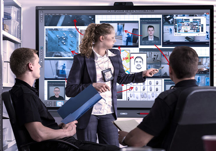 Collaboration on an investigation using a SMART Board in a law enforcement setting.