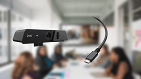 Close-up view of the SMART Ultra HD Camera 120 with a USB-C Cable 18 in focus, in a blurred meeting room environment.