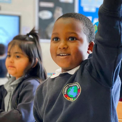 Young student raising hand in a classroom