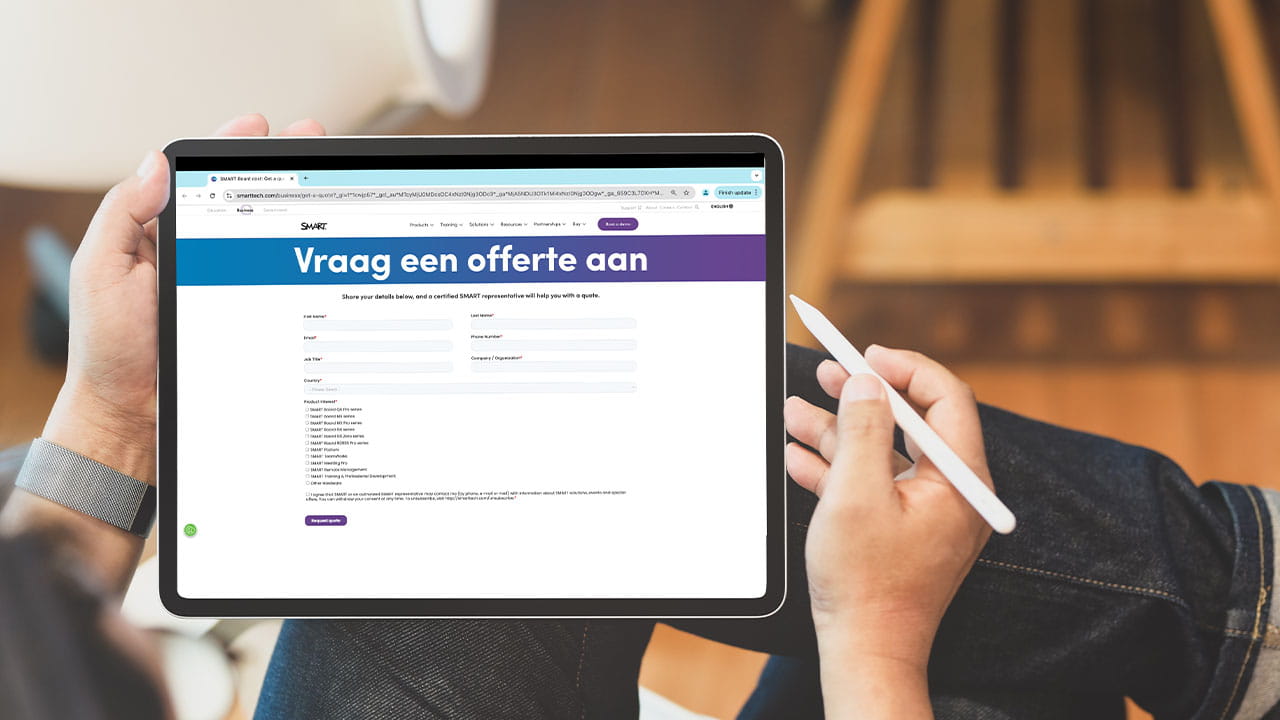 A person holding a tablet displaying the SMART 'Request a Quote' page, showcasing fields for submitting business/organization details.